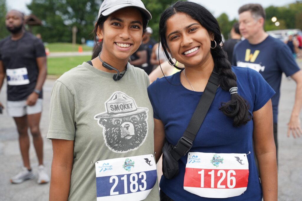 Runners pose with race bibs